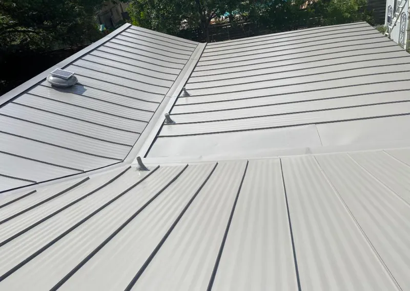Solar attic fan installed on a metal roof for Roof Ventilation in Missoula