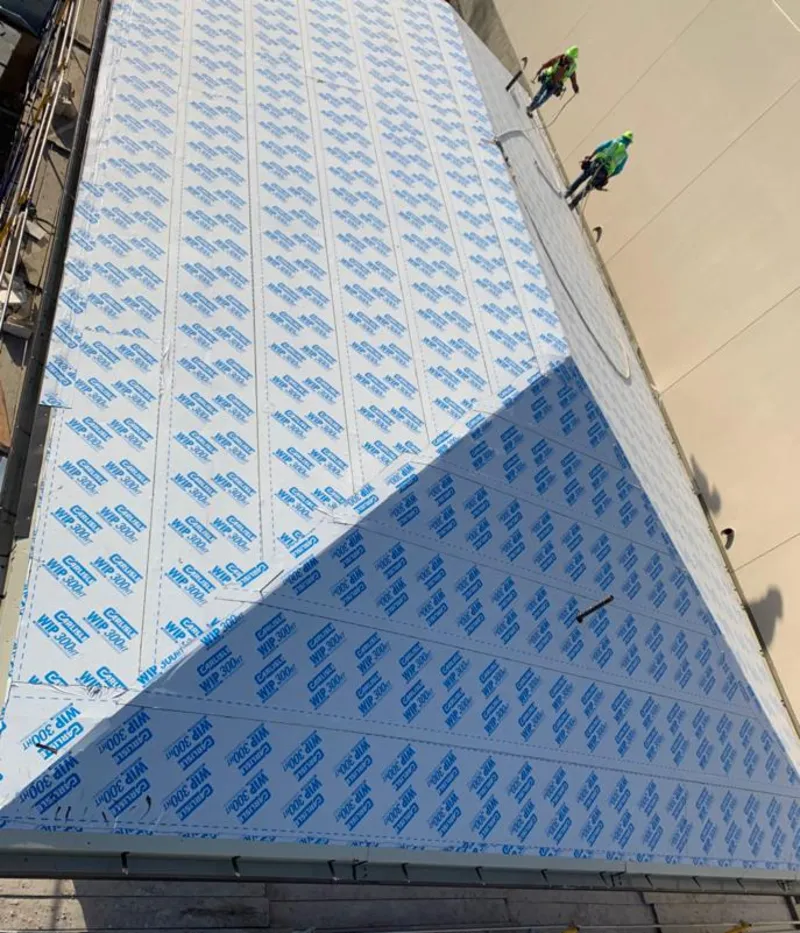 Professional roofers installing underlayment on a metal roof in Missoula